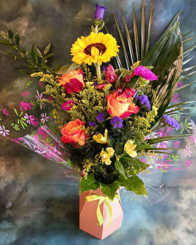 Sunlit Radiance - A vibrant and cheerful arrangement perfect for bringing a touch of colour into any room or celebrating happy moments. Pease note: sunflowers are subject to availability and may be substituted on a florist choice basis.