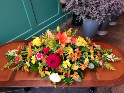 Autumnal spray - This vibrant floral spray is a celebration of warm autumnal tones, featuring an array of stunning blooms.